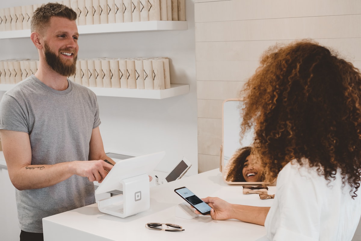 A small business counter with a card reader and customer checkout area